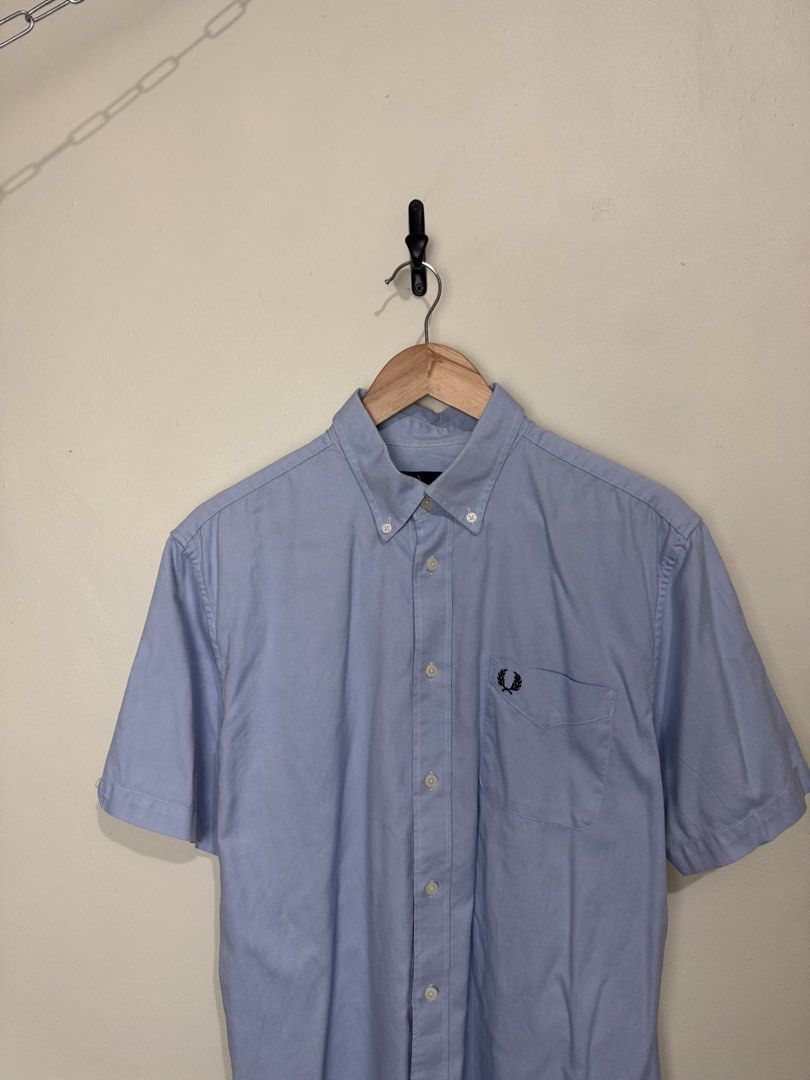 Fred Perry Short Sleeve Button Up Shirt Light Blue (Category: Tshirts & Polo Shirts ) located in San Jose. Submitted by strictlyRL (Listing ID 1462365792, Image 2). Description: - Brand: Fred Perry - Color: Light Blue - Sleeve Length: Short Sleeve - Style: Button-up Shirt - Collar: Button-down - Features: Embroidered classic laurel wreath logo on chest pocket - Size: L - Occasion: Casual wear, smart casual outfits 22-22.5 width 28 length (inches)