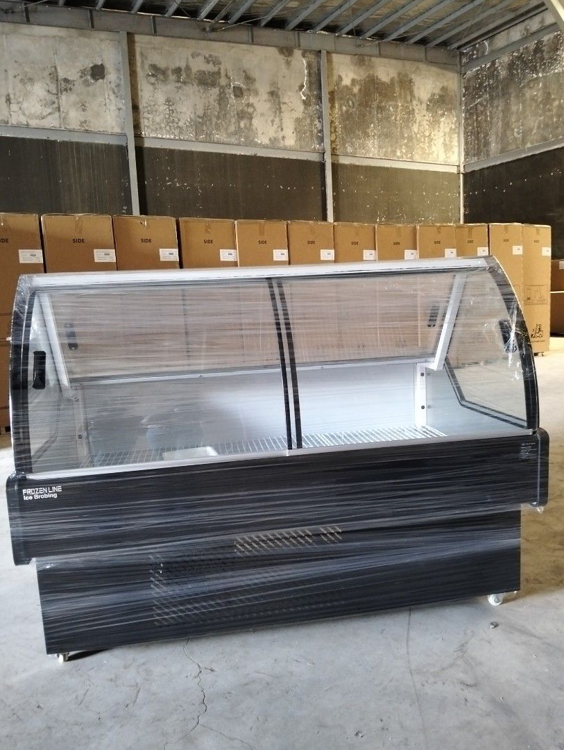 Frozenline Ice Broiling Display Refrigerator (Category: Refrigerators and Freezers) located in Liloan. Submitted by jen_adartel (Listing ID 1462281728, Image 2). Description: - Frozenline Ice Broiling display refrigerator - Curved glass front with sliding doors - Ideal for displaying chilled food items - Features internal shelves - Some units still wrapped in plastic - Located in a warehouse - Ready for pickup.