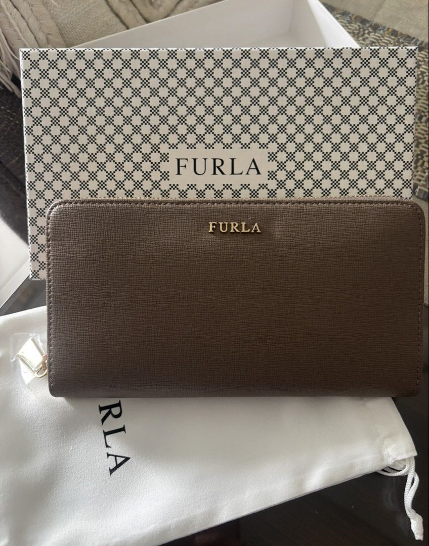 Furla Brown Leather Zip Around Wallet (Category: Wallets & Card holders) located in Manila. Submitted by ivygen2708629 (Listing ID 1462389341, Image 1). Description: - Genuine brown leather Furla wallet - Secure zip-around closure - Multiple card slots and compartments for excellent organization - Comes with original box and dust bag.