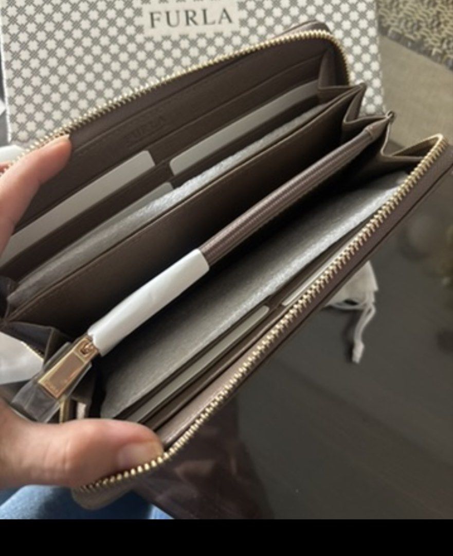Furla Brown Leather Zip Around Wallet (Category: Wallets & Card holders) located in Manila. Submitted by ivygen2708629 (Listing ID 1462389341, Image 2). Description: - Genuine brown leather Furla wallet - Secure zip-around closure - Multiple card slots and compartments for excellent organization - Comes with original box and dust bag.