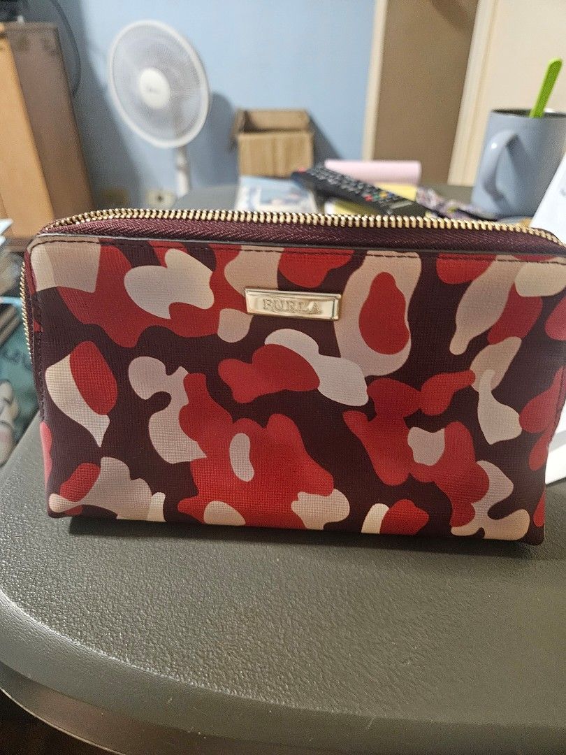 Furla Camouflage Zip Around Wallet (Category: Luxury Bags & Wallets) located in Manila. Submitted by hausofgadgetatbp (Listing ID 1462409675, Image 1). Description: - Stylish Furla wallet with a unique red and beige camouflage print. - Secure zip-around closure to keep your belongings safe. - Comes with original dust bag and authenticity card for peace of mind. - Ideal for keeping your daily essentials neatly organized..