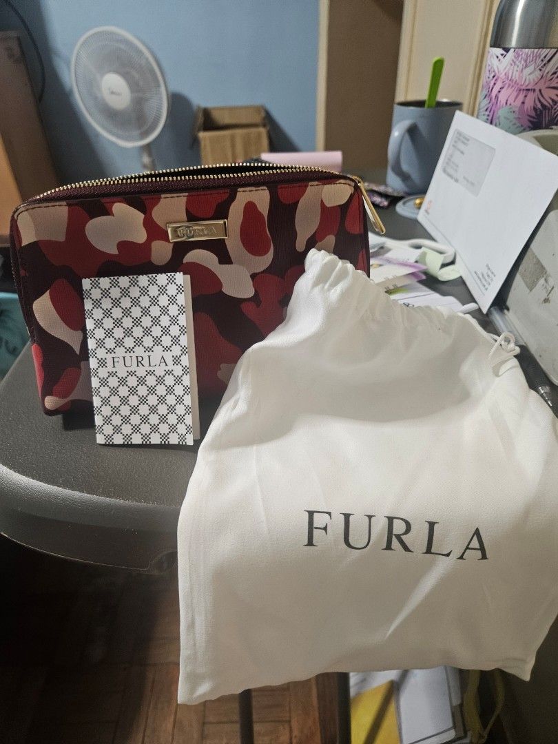Furla Camouflage Zip Around Wallet (Category: Luxury Bags & Wallets) located in Manila. Submitted by hausofgadgetatbp (Listing ID 1462409675, Image 3). Description: - Stylish Furla wallet with a unique red and beige camouflage print. - Secure zip-around closure to keep your belongings safe. - Comes with original dust bag and authenticity card for peace of mind. - Ideal for keeping your daily essentials neatly organized..
