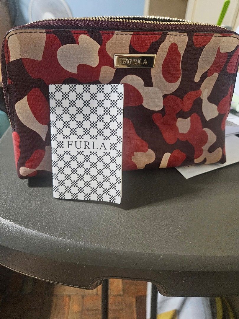 Furla Camouflage Zip Around Wallet (Category: Luxury Bags & Wallets) located in Manila. Submitted by hausofgadgetatbp (Listing ID 1462409675, Image 2). Description: - Stylish Furla wallet with a unique red and beige camouflage print. - Secure zip-around closure to keep your belongings safe. - Comes with original dust bag and authenticity card for peace of mind. - Ideal for keeping your daily essentials neatly organized..