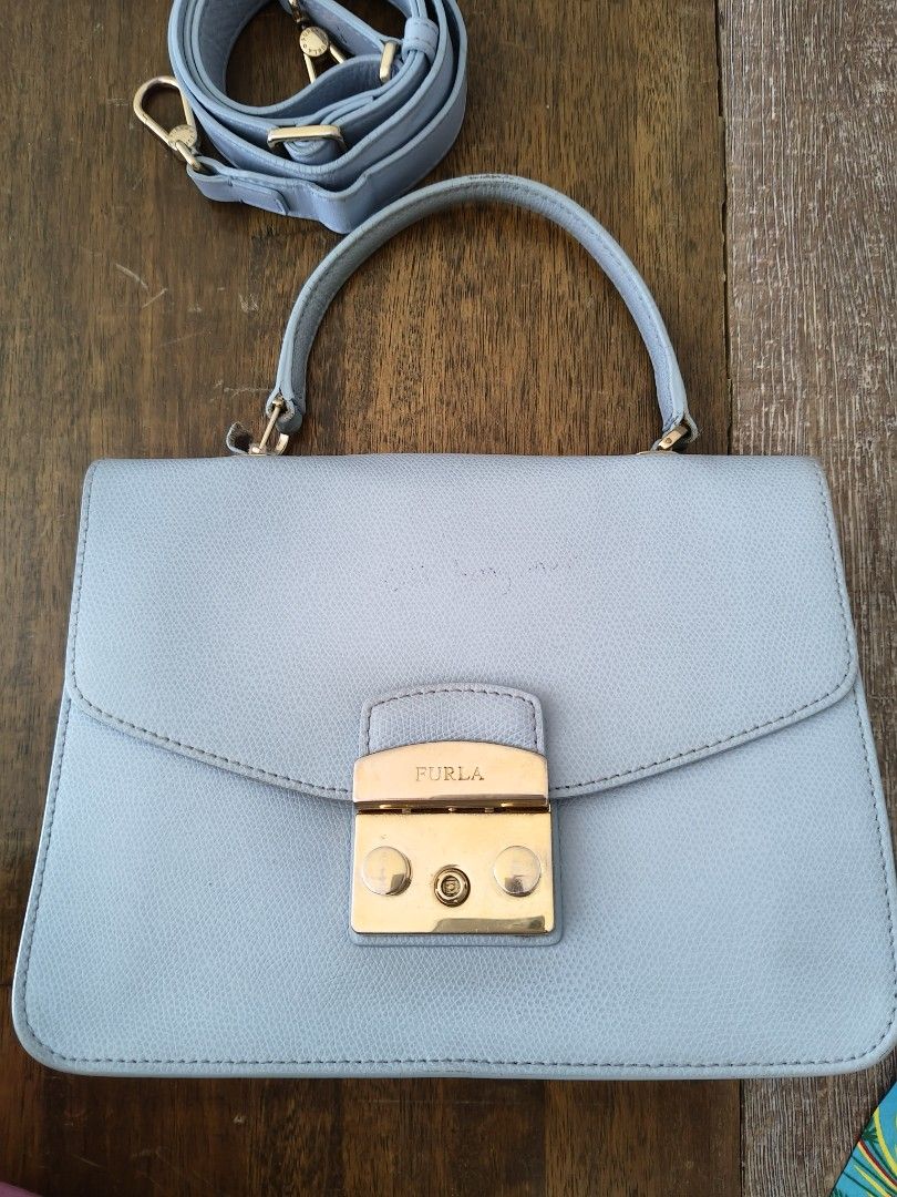 🩵Furla Metropolis Top Handle Mini Bag Light Blue (Category: Luxury Bags & Wallets) located in Tarlac. Submitted by momma02 (Listing ID 1462289701, Image 1). Description: - Light blue Furla Metropolis mini bag Made of saffiano leather. The bag features a push lock closure that opens to fabric lining with interior one slip pocket. -negiotiable, pls send reasonable offer Details: 23 x 8 x 17 Cm Gold tone hardware Saffiano leather Push lock closure 