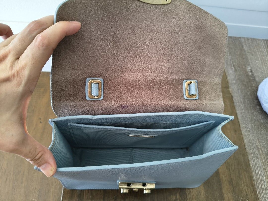 🩵Furla Metropolis Top Handle Mini Bag Light Blue (Category: Luxury Bags & Wallets) located in Tarlac. Submitted by momma02 (Listing ID 1462289701, Image 3). Description: - Light blue Furla Metropolis mini bag Made of saffiano leather. The bag features a push lock closure that opens to fabric lining with interior one slip pocket. -negiotiable, pls send reasonable offer Details: 23 x 8 x 17 Cm Gold tone hardware Saffiano leather Push lock closure 
