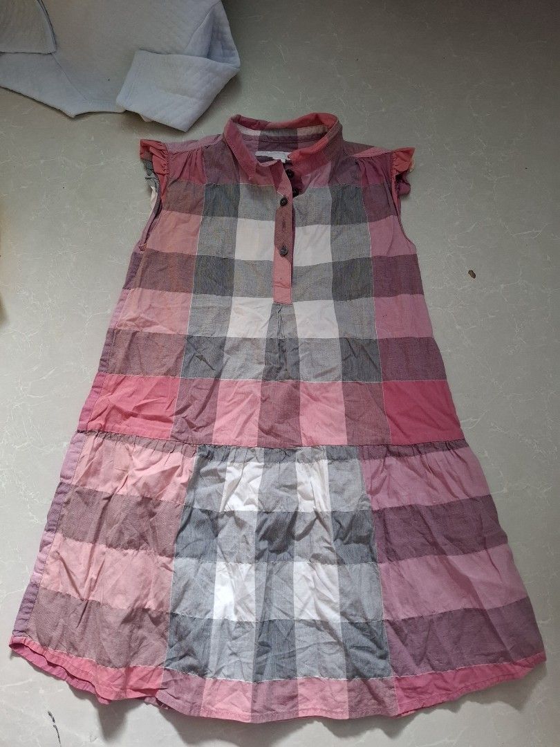 Girls' Plaid Dress (Category: Babies & Kids Fashion) located in Pasay City. Submitted by al1son18 (Listing ID 1462271763, Image 1). Description: - Adorable plaid dress for girls - Classic pink, grey, and white checkered pattern - Easy button-up front - Charming ruffled sleeves - Versatile for casual wear or parties - Simple to put on and take off.