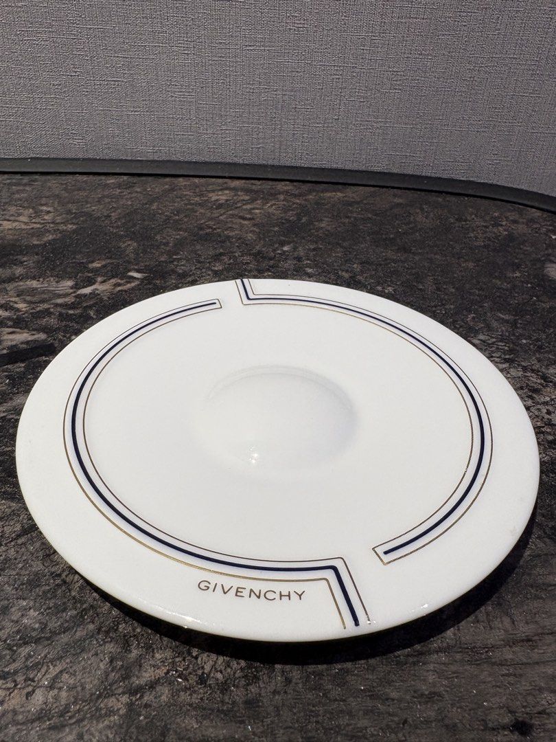 Givenchy Espresso Cup and Saucer Set (Category: Coffee & Tea Tableware) located in Manila. Submitted by foundhouseph (Listing ID 1462367050, Image 2). Description: - White porcelain espresso cup and saucer - Features elegant gold and navy blue stripe details - Authentic Givenchy logo on both cup and saucer - Ideal for enjoying your morning espresso - Doubles as a sophisticated display piece - Clean and timeless design - With minimal gold rub on t
