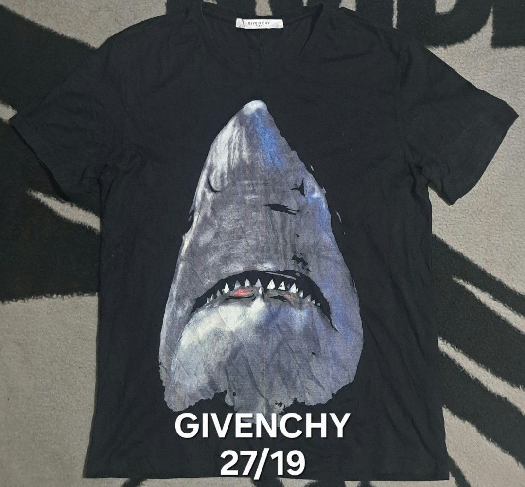 Givenchy Paris Shark Print T-Shirt Size M (Category: Tshirts & Polo Shirts ) located in San Fernando, Camarines Sur. Submitted by ladderaya (Listing ID 1462323485, Image 1). Description: - Givenchy Paris T-Shirt - Color: Black - Iconic Shark Graphic Print - Size: Medium (M) - Material: 100% Cotton - Secondary Fabric: Viscose & Silk - Origin: Made in Portugal - Perfect addition to any fashion collection.