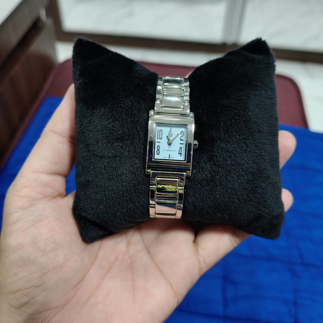 Givenchy Square Face Watch (Category: Luxury Watches) located in San Pedro. Submitted by charmz24 (Listing ID 1462381740, Image 1). Description: - Authentic Givenchy watch - Elegant square face - Light blue dial - Silver-toned metal band -Battery powered model - Original Box is missing - Versatile for daily wear or special events RFS: not using anymore .