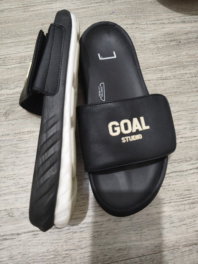 GOAL STUDIO Black Slides Sandals - US8 (Category: Slippers & Slides) located in Calamba. Submitted by an_ne0501 (Listing ID 1462298295, Image 2). Description: - Brand: GOAL STUDIO - Color: Black - Size: 40.5 EU / US8 / 25cm - Features: Adjustable strap for a secure fit - Sole: Unique hexagonal pattern - Ideal for: Casual outings or post-sport relaxation.