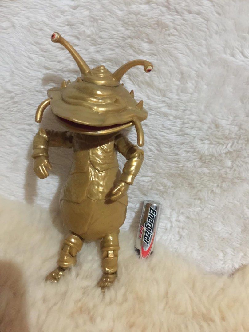 Gold Alien Insectoid Action Figure Toy (Category: Figurines & Statues) located in Baguio. Submitted by izza_thrifty (Listing ID 1462436860, Image 2). Description: - Unique gold alien insectoid action figure - Stands independently - Features articulated joints for dynamic posing - Approximately the size of a soda can - Ideal for collectors and display purposes.