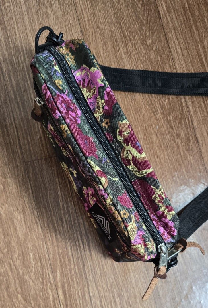 Gregory Floral Crossbody Bag (Category: Cross-body Bags) located in Quezon. Submitted by archivesss_666 (Listing ID 1462372737, Image 2). Description: - Gregory crossbody bag with a vibrant floral print. - Main zippered compartment for secure storage. - Additional front zippered pocket for quick access. - Adjustable strap for a customized, comfortable fit. - Ideal for everyday errands or travel adventures. - Please note: Leather zipper pulls show