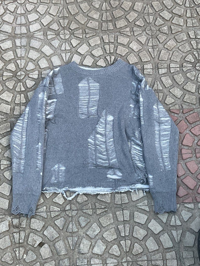 Grey Distressed Knit Sweater cropped (Category: Coats, Jackets and Outerwear) located in Mabalacat. Submitted by epicforest_78284 (Listing ID 1462400072, Image 1). Description: - Grey knit sweater with all-over distressed details. - Features long sleeves and a classic crew neck. - Ribbed cuffs and hem for a comfortable fit. - Trendy raw hemline at the bottom. - Ideal for layering or wearing as a standalone statement piece..