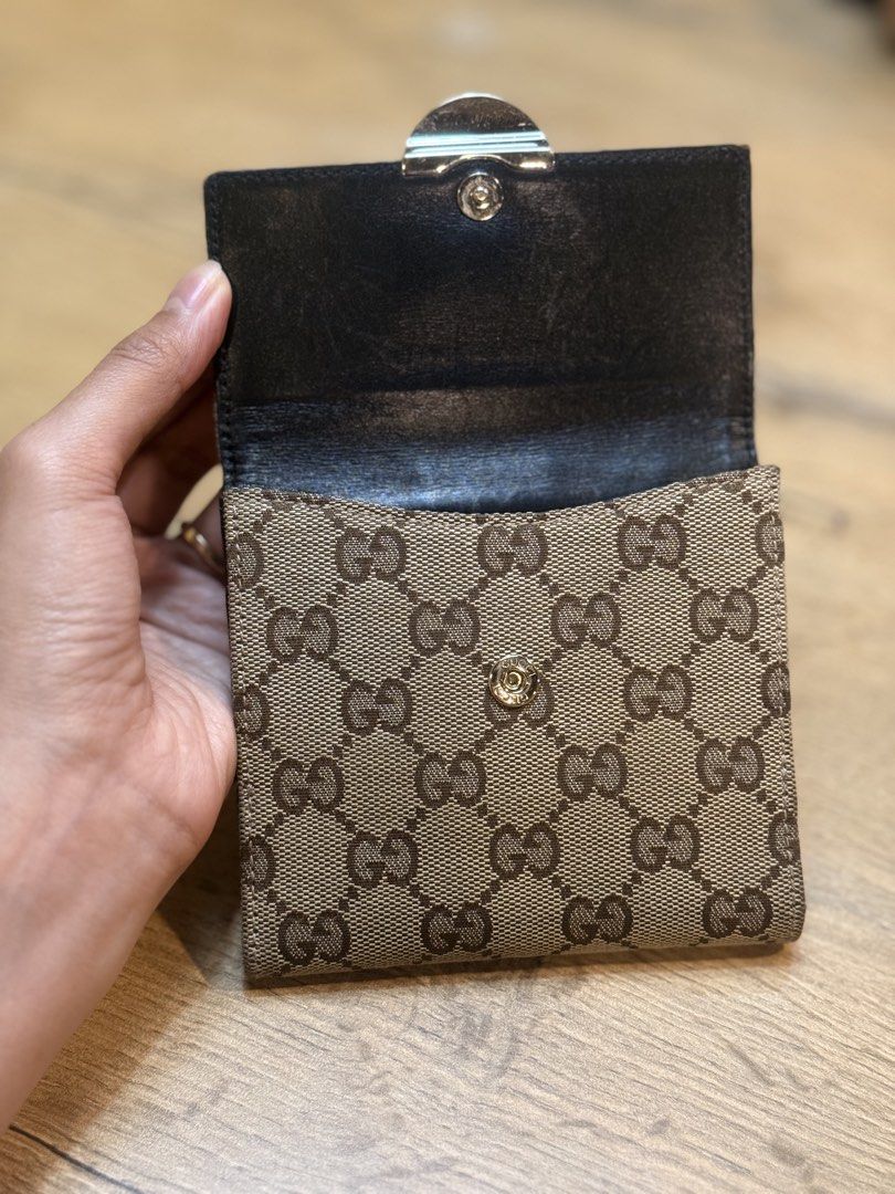 Gucci GG Canvas Wallet with Lock Closure (Category: Luxury Bags & Wallets) located in Pasig City. Submitted by riusables (Listing ID 1462359481, Image 2). Description: - Authentic Gucci wallet - Classic GG canvas pattern - Secure front lock closure - Multiple interior card slots and compartments - Black leather lining - Condition: 9/10 - Price negotiable Rfs: need funds .