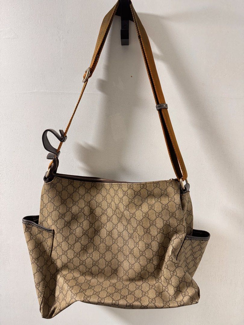 Gucci Monogram Canvas Shoulder Bag (Category: Luxury Bags & Wallets) located in Cavite. Submitted by aldrindela40142 (Listing ID 1462334084, Image 3). Description: - Gucci shoulder bag - Classic GG monogram canvas - Brown leather trim and strap - Zip top closure - Exterior side pockets - Interior zip and slip pockets - Made in Italy - Great everyday bag.