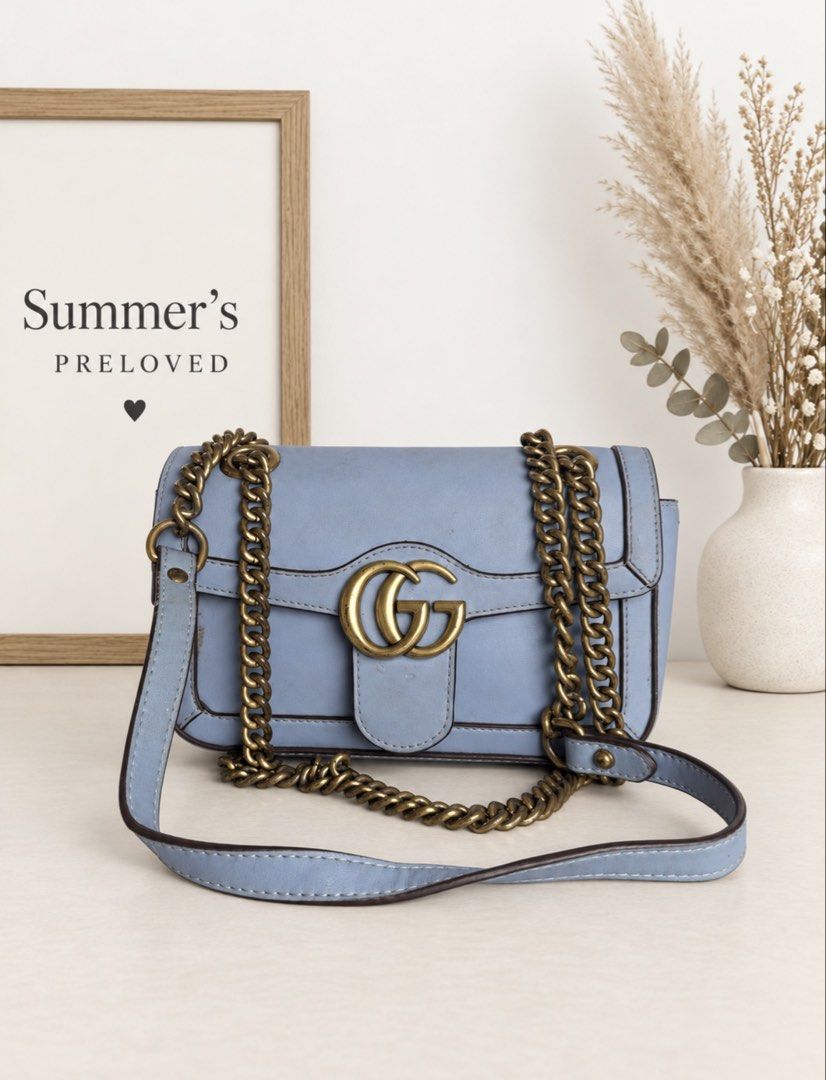 Gucing Marmont Flap leather bag (Category: Shoulder Bags) located in Taguig. Submitted by summers.preloved (Listing ID 1462414217, Image 1). Description: 👜 Bag Details 🩵 Powder-blue leather exterior 💜 Signature interlocking Gucing emblem 🔗 Antique gold-tone sliding chain strap with leather shoulder section 🔒 Push-lock flap closure 🤎 Contrast dark-brown edge finishing 🧵 Structured rectangular silhouette 🤍 Light beige fabric-lined interior 