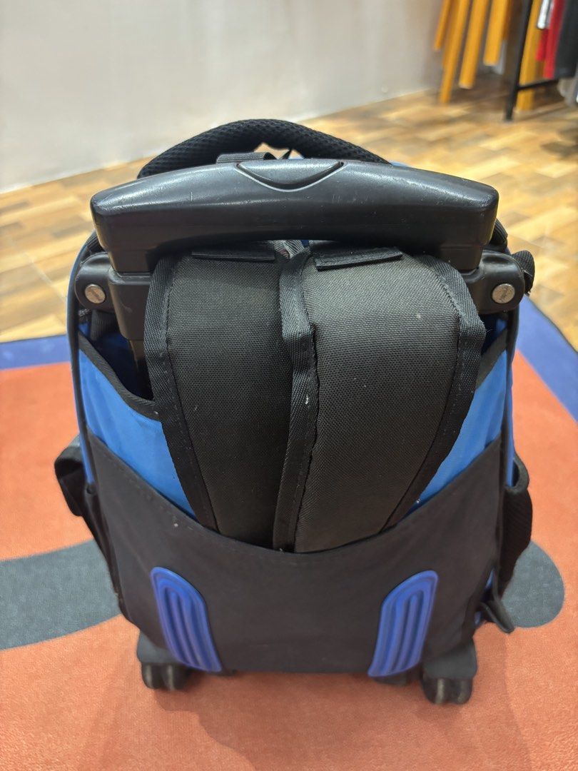 Hawk Rolling Backpack with Wheels (Category: Backpacks) located in Alicia. Submitted by thriftbagph (Listing ID 1462417662, Image 3). Description: - Blue and black Hawk rolling backpack - Features a cool geometric pattern on the front pocket - Two wheels for easy transport - Extendable handle at the top - Plenty of space inside - Ideal for school or travel.