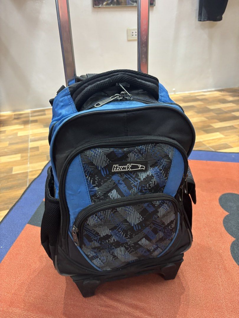 Hawk Rolling Backpack with Wheels (Category: Backpacks) located in Alicia. Submitted by thriftbagph (Listing ID 1462417662, Image 2). Description: - Blue and black Hawk rolling backpack - Features a cool geometric pattern on the front pocket - Two wheels for easy transport - Extendable handle at the top - Plenty of space inside - Ideal for school or travel.