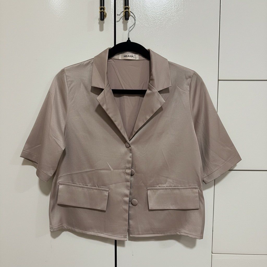 HEAHA Satin Cropped Blazer - Beige (Category: Blouses) located in Angeles City. Submitted by momandmini9 (Listing ID 1462367708, Image 2). Description: - Brandnew - Beige satin cropped blazer - Short sleeves - Lapel collar - Two front pockets - Button closure - Versatile for dressing up or down - Free size; can fit up to Large - Original Price 600 - From Thailand .