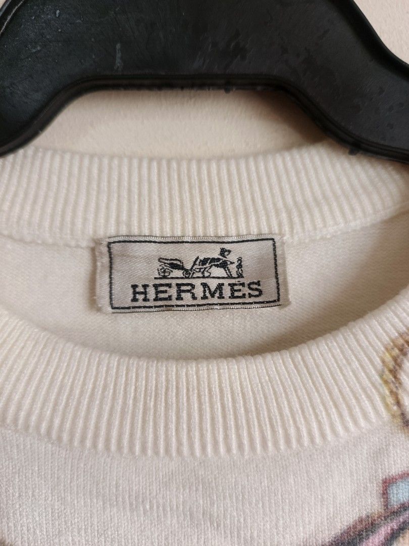 HERMES (Category: Longsleeves) located in Dasmarinas. Submitted by jessicamae43174 (Listing ID 1462279731, Image 3). Description: - White knit sweater - Features classic Hermes horsebit print - Crew neck and long sleeves - Detailed equestrian motifs - Versatile for layering or standalone wear - Timeless Hermes piece.