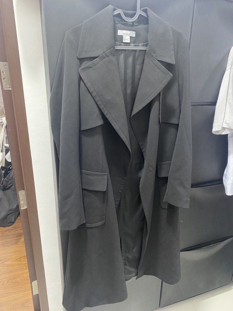 H&M Black Long Trench Coat (Category: Coats, Jackets and Outerwear) located in San Juan City. Submitted by louvefinds (Listing ID 1462334577, Image 3). Description: - Classic black trench coat from H&M - Long length - Double-breasted lapel style - Two front pockets - Fully lined interior - Ideal for layering over outfits - Versatile wardrobe staple.