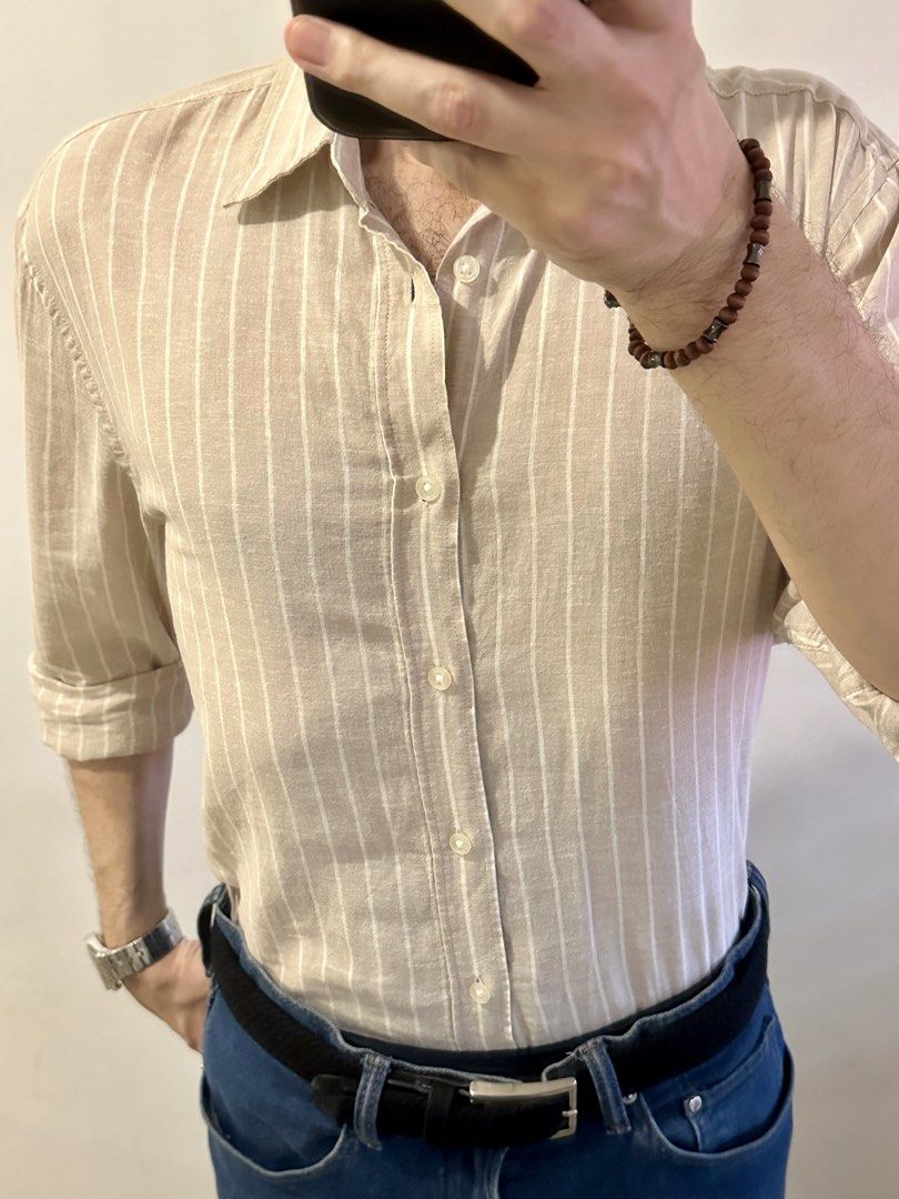 H&M Regular Fit Striped Shirt (Category: Tshirts & Polo Shirts ) located in Manila. Submitted by chris9837 (Listing ID 1462409858, Image 1). Description: - H&M shirt - Beige with thin white vertical stripes - Regular fit - Button-up front with a collar - Sleeves can be rolled up for versatility - Comfortable and casual style Location: Parañaque. .