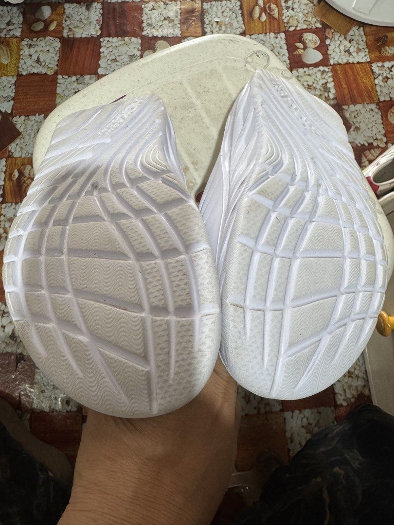 Hoka One 100% authentic (Category: Slippers & Slides) located in Manila. Submitted by wildbear.e10374 (Listing ID 1462308634, Image 3). Description: - White Hoka One One slides - Comfortable and easy to wear - Features a good grip sole pattern - Made in Vietnam - Ideal for casual outings or after sports activities.