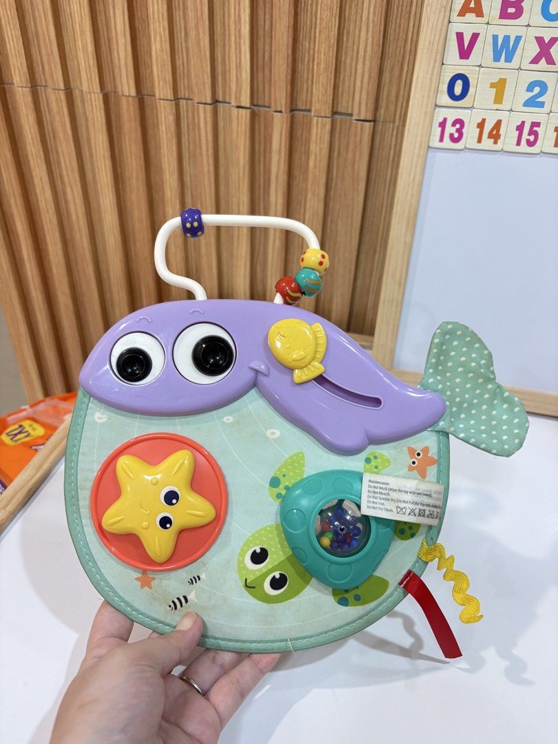 Infantino Whale Musical Activity Toy (Category: Infant Playtime) located in Quezon City. Submitted by sailormooooo (Listing ID 1462398690, Image 1). Description: - Adorable whale-shaped activity toy for babies. - Includes a spinning starfish, a rattle, and musical sounds. - Features a convenient handle for easy carrying or stroller attachment. - Bright, engaging colors and varied textures stimulate sensory exploration. - Promotes the development 