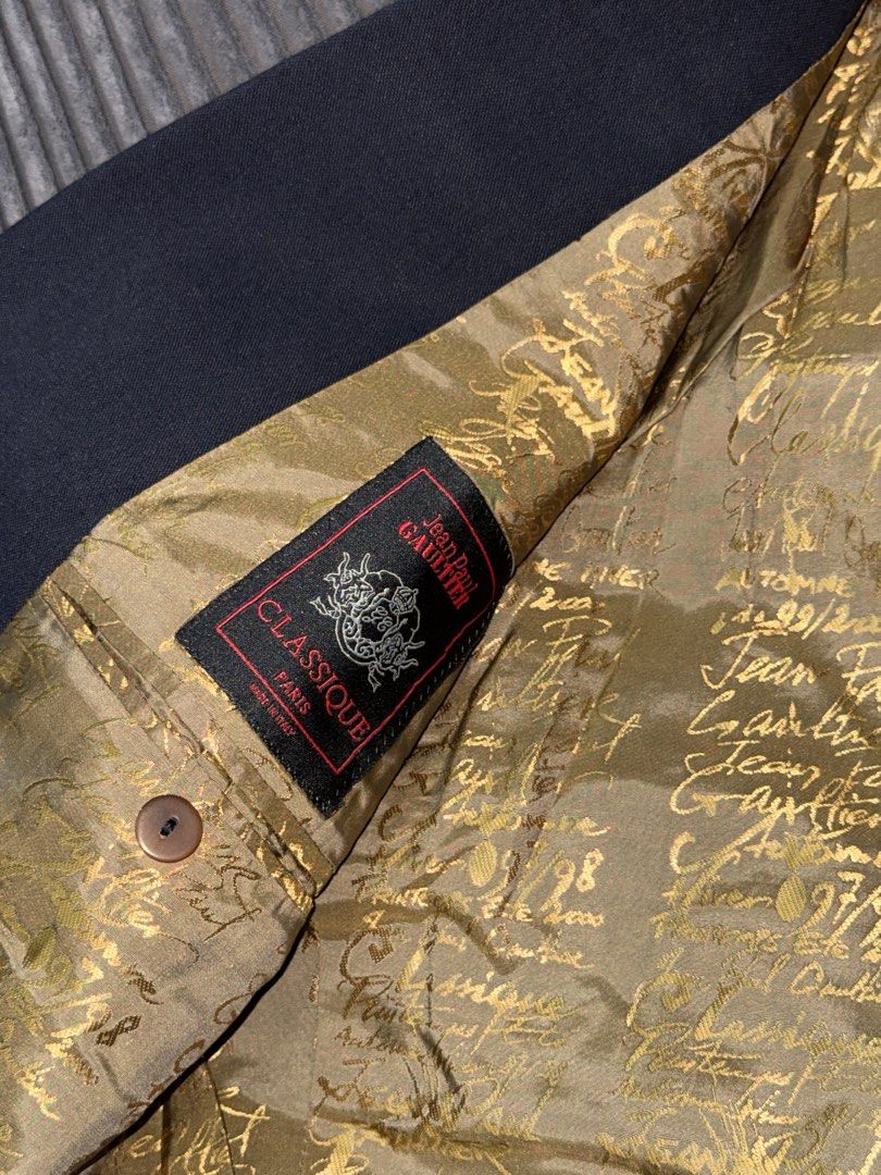 Jean Paul Gaultier Classique Double-Breasted Blazer (Category: Vests) located in Angeles City. Submitted by migs_font29 (Listing ID 1462386907, Image 2). Description: - Classic Jean Paul Gaultier double-breasted blazer - Elegant black exterior - Striking gold patterned lining - Made in Italy - Size: 46 IT / 36 US - A must-have for fashion enthusiasts.