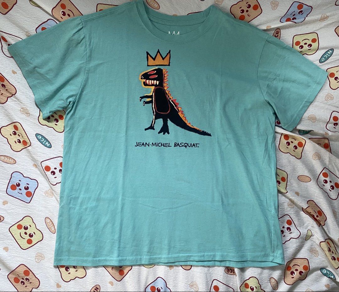 Jean-Michel Basquiat T-Shirt (Category: Tshirts & Polo Shirts ) located in Davao. Submitted by _belalua (Listing ID 1462343232, Image 2). Description: - Cool teal t-shirt - Features iconic Jean-Michel Basquiat dinosaur graphic - Size: LG/G/G - Material: 60% cotton, 40% polyester - Easy to wash - Perfect for art lovers.