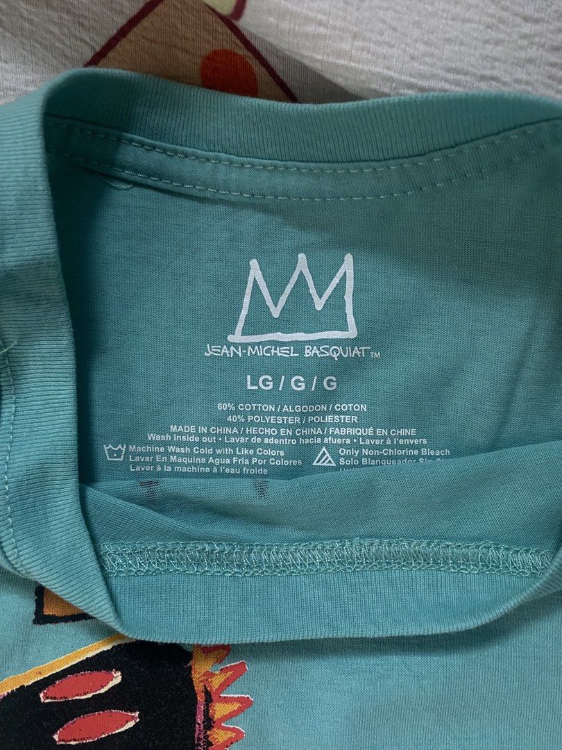 Jean-Michel Basquiat T-Shirt (Category: Tshirts & Polo Shirts ) located in Davao. Submitted by _belalua (Listing ID 1462343232, Image 3). Description: - Cool teal t-shirt - Features iconic Jean-Michel Basquiat dinosaur graphic - Size: LG/G/G - Material: 60% cotton, 40% polyester - Easy to wash - Perfect for art lovers.