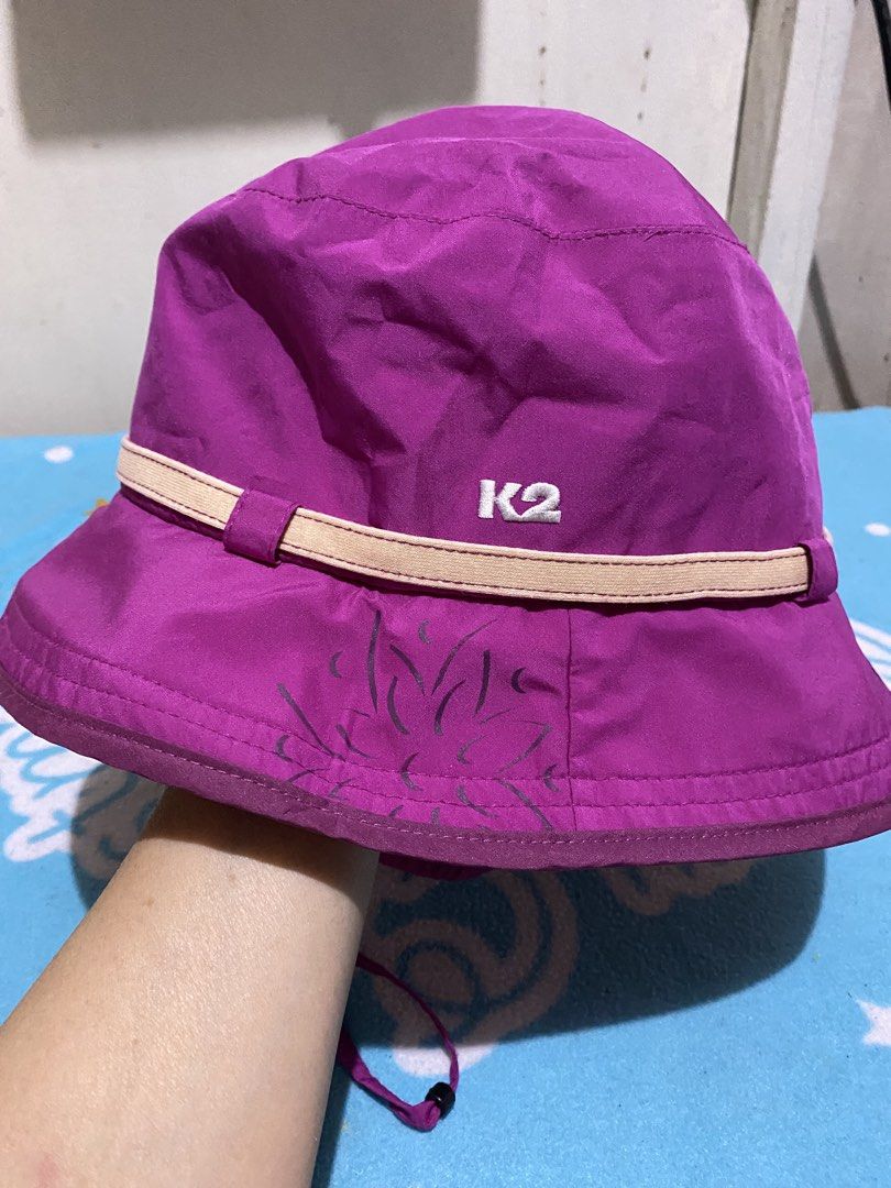 K2 Purple Bucket Hat with Chin Strap (Category: Hats & Beanies) located in Manila. Submitted by resi.diaz (Listing ID 1462411619, Image 3). Description: - K2 purple bucket hat - Light beige band around the crown - Adjustable chin strap with toggle - Subtle floral design on the front - Ideal for sunny outdoor activities - Easy to pack and wear.