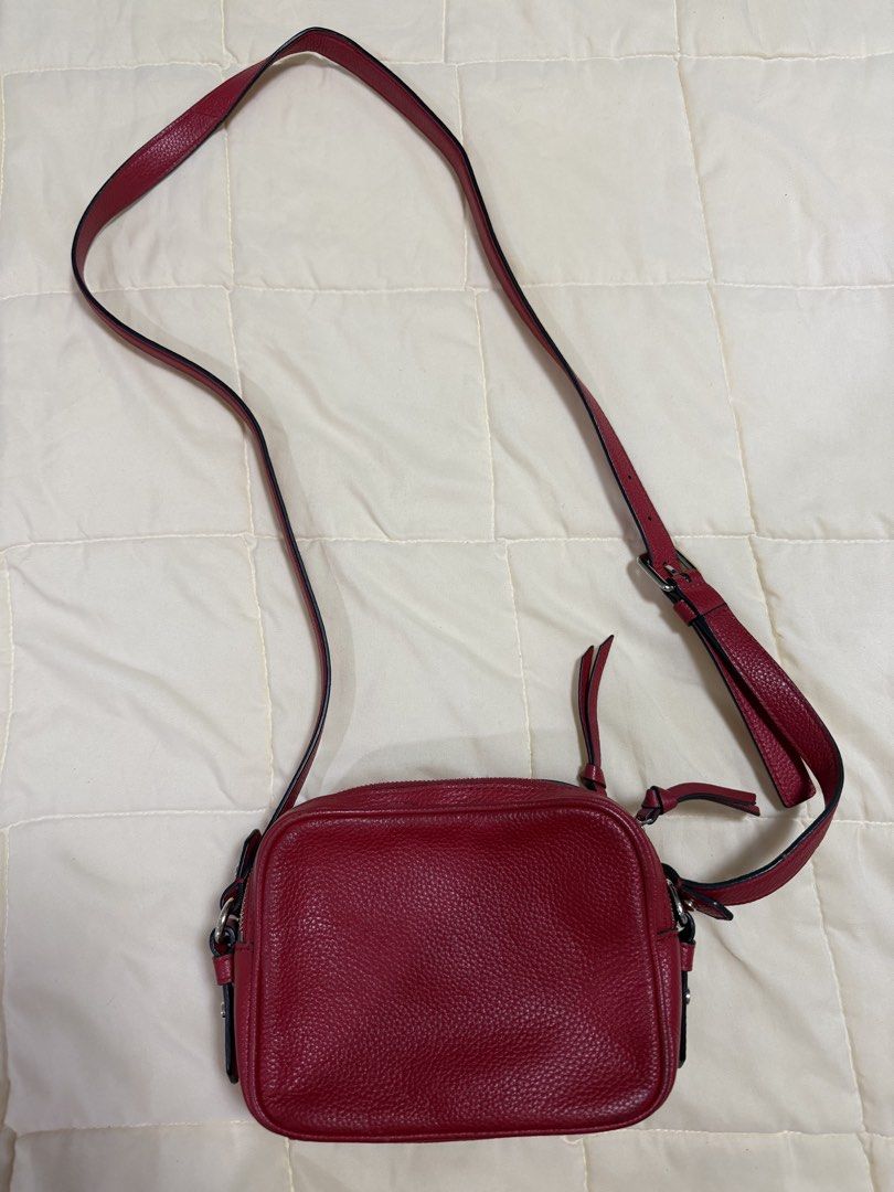 Kate Spade Red Leather Crossbody Bag (Category: Cross-body Bags) located in Paranaque City. Submitted by kimgcham (Listing ID 1462376599, Image 2). Description: - Authentic Kate Spade crossbody bag in vibrant red. - Made from durable, textured pebble leather. - Secure zipper closure to keep your belongings safe. - Adjustable strap for comfortable crossbody wear. - Compact size, ideal for carrying just the essentials. - Stylish silver hardware acc