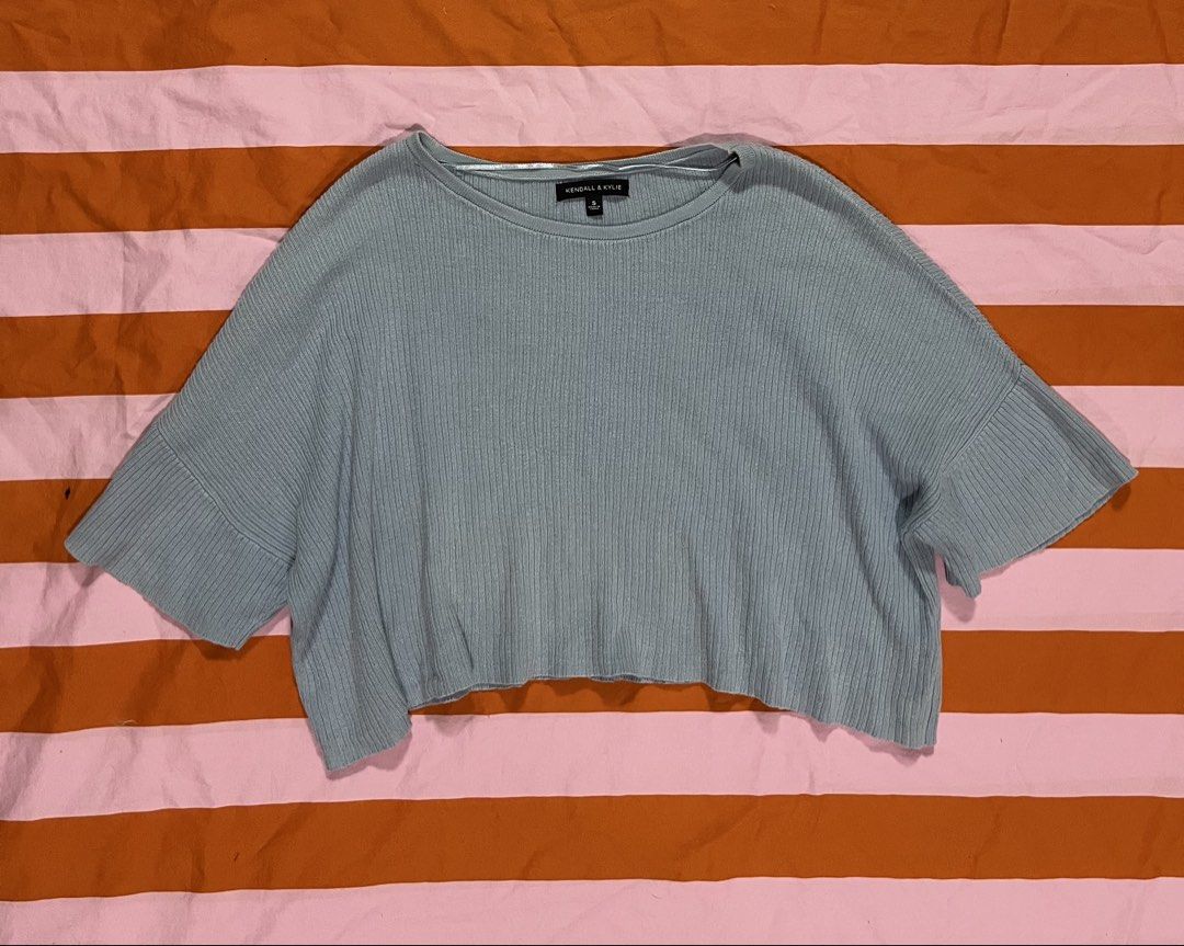 Kendall & Kylie Light Blue Ribbed Cropped Top (Category: Shirts) located in Mandaluyong City. Submitted by hopeworldplane (Listing ID 1462420262, Image 1). Description: - Light blue cropped top - Brand: Kendall & Kylie - Ribbed texture all over - Short, wide sleeves - Elasticated hem - Comfortable and stylish design - Ideal for casual outfits.