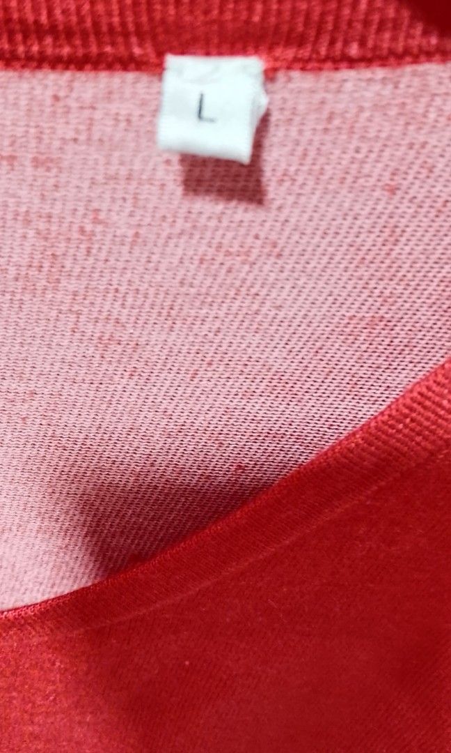 Knitted coral orange tops (Category: Blouses) located in Cabanatuan. Submitted by miss.maia (Listing ID 1462433982, Image 3). Description: The image shows a coral-red long-sleeve knit top with a wide scoop neckline and side-tie knot details at the hem..