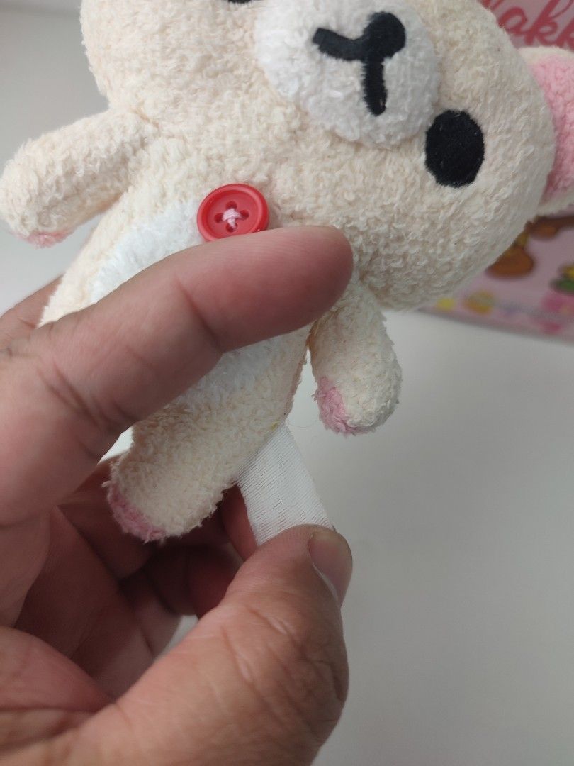koRilakkuma Plush Keychain with Button Detail (Category: Plushies & Soft Toys) located in Manila. Submitted by epicmountain-f20453 (Listing ID 1462408335, Image 3). Description: - Adorable Rilakkuma plush keychain - Cream colored with cute pink ear and foot accents - Features a charming red button on its chest - Comes with a durable metal chain for easy hanging - A must-have collectible for any Rilakkuma enthusiast!.