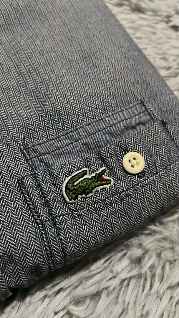 Lacoste Live Blue Herringbone Button Down Shirt (Category: Tshirts & Polo Shirts ) located in Cebu City. Submitted by johnova18 (Listing ID 1462434784, Image 2). Description: Lacoste Live Gray Pocket Button Down LS Authentic ✅ Size: Small Width: 18 Length: 26 Color rate: 10/10 Pristine condition Good As New 2500 + shipping fee Location: Cebu City.