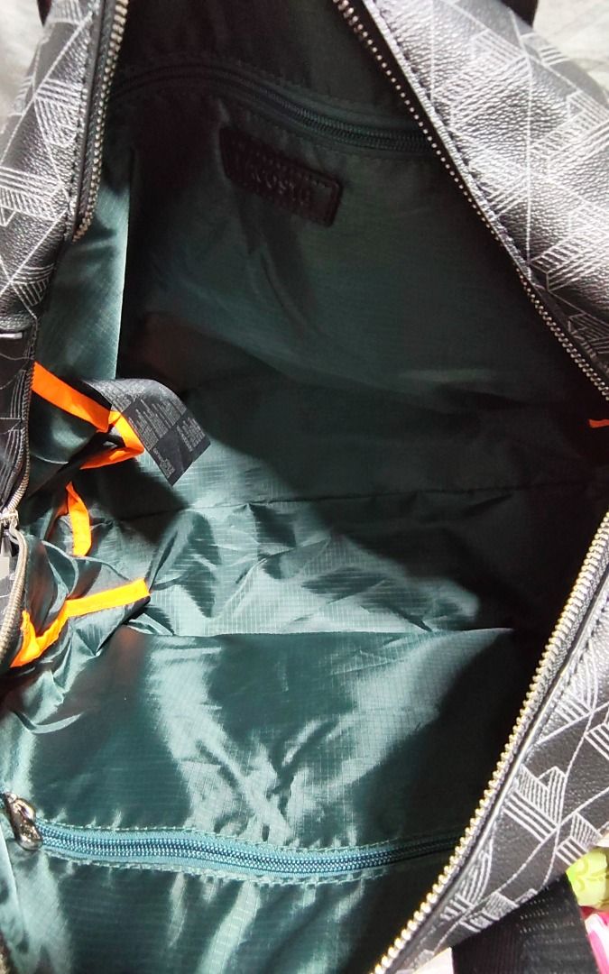Lacoste Monogram Duffel Bag (Category: Luxury Bags & Wallets) located in Caloocan City. Submitted by jpmshoppe (Listing ID 1462317830, Image 2). Description: - Authentic Lacoste duffel bag - All-over black and white monogram print - Features top handles and a detachable shoulder strap - Spacious main compartment for all your essentials - Convenient front zip pocket for smaller items - Comes with original tags attached.