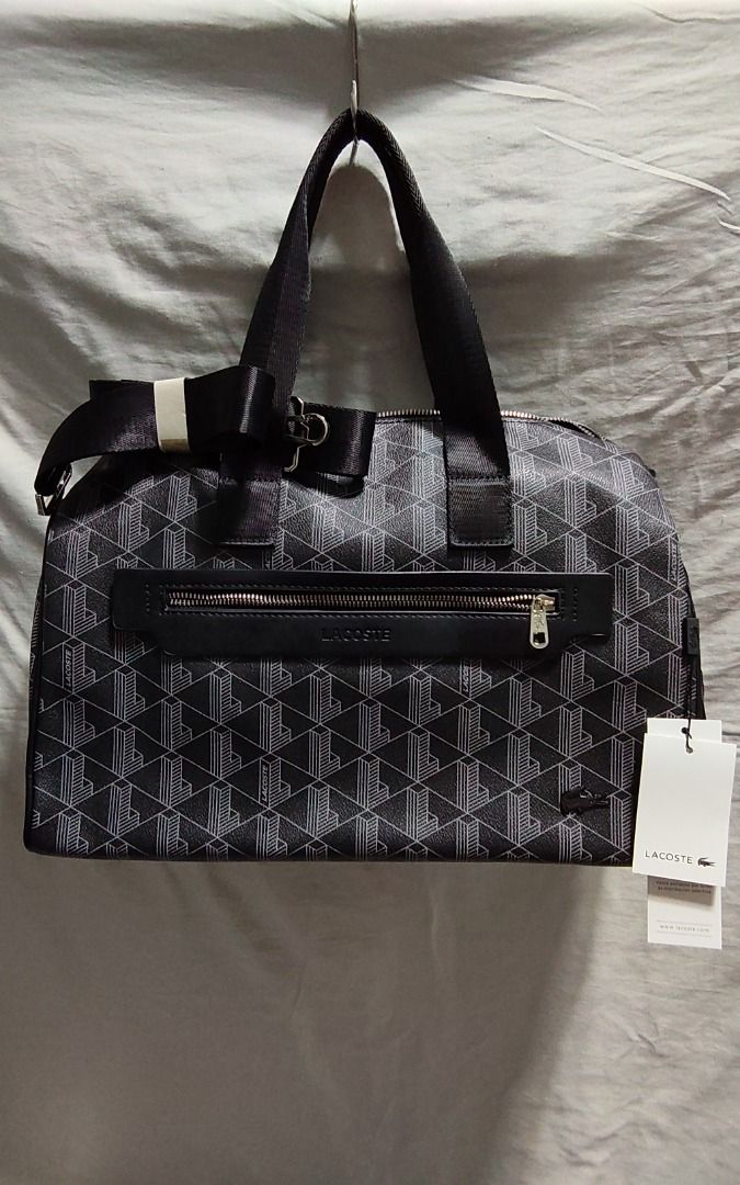 Lacoste Monogram Duffel Bag (Category: Luxury Bags & Wallets) located in Caloocan City. Submitted by jpmshoppe (Listing ID 1462317830, Image 1). Description: - Authentic Lacoste duffel bag - All-over black and white monogram print - Features top handles and a detachable shoulder strap - Spacious main compartment for all your essentials - Convenient front zip pocket for smaller items - Comes with original tags attached.
