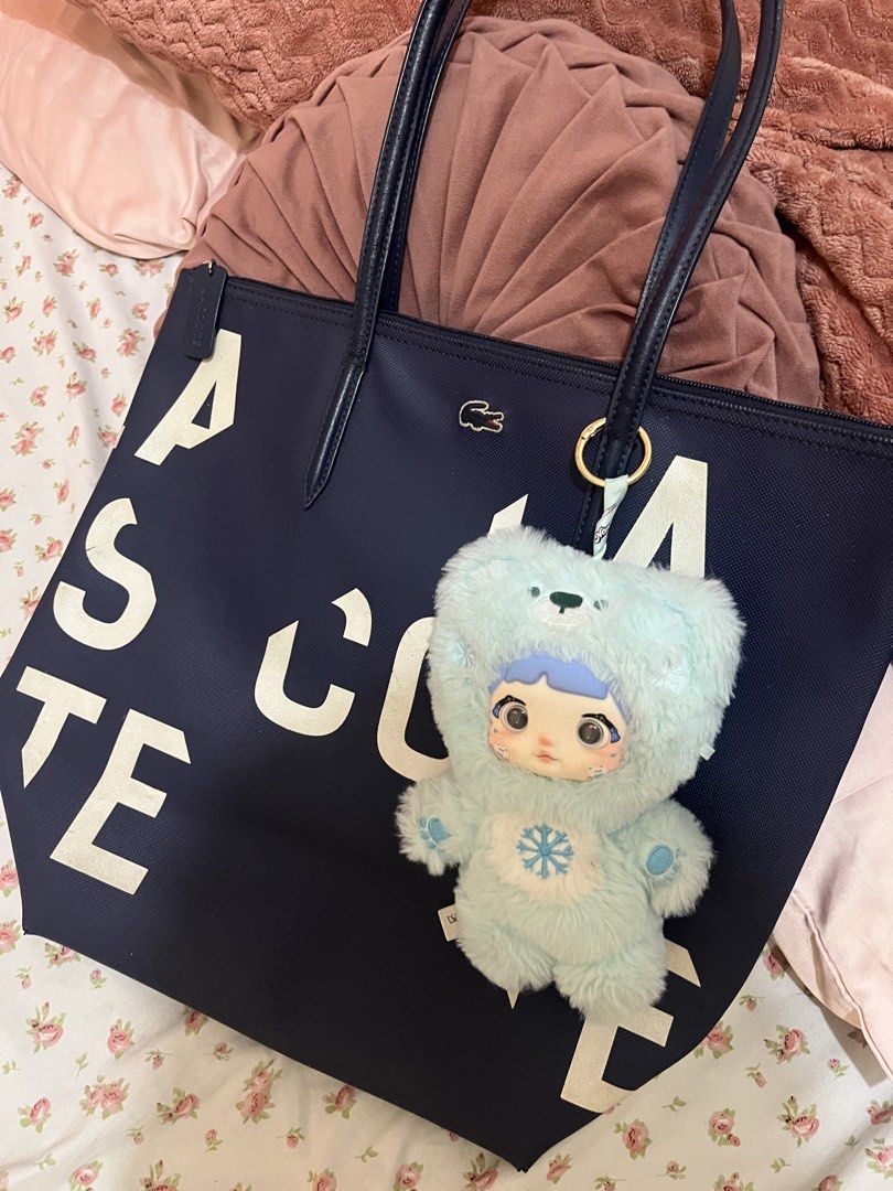 Lacoste Navy Blue Tote Bag with Charm (Category: Tote Bags) located in Manila. Submitted by newwater.3ba52b (Listing ID 1462300189, Image 1). Description: - Navy blue Lacoste tote bag - Large size, ideal for everyday use - White lettering on the front - Dark blue handles.