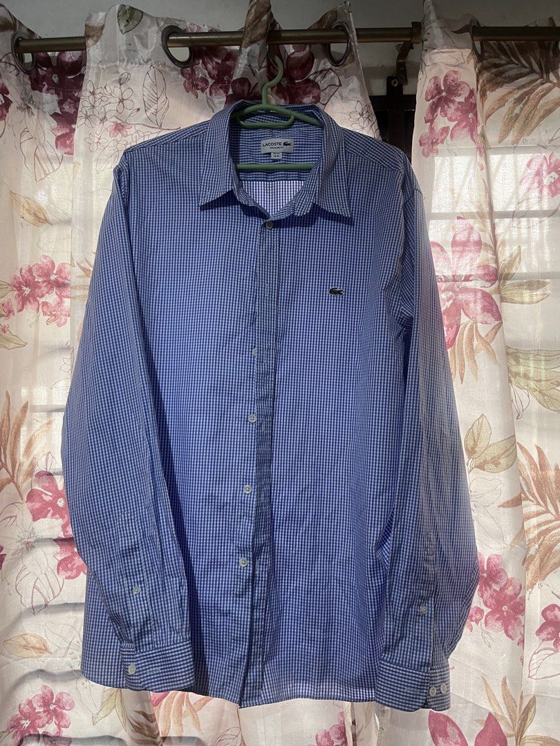 Lacoste Regular Fit Long Sleeve Shirt (Category: Tshirts & Polo Shirts ) located in Manila. Submitted by acloset.mnl (Listing ID 1462403041, Image 1). Description: - Classic blue and white gingham pattern - Lacoste long-sleeve shirt - Regular fit - Iconic embroidered crocodile logo on chest - Button-up front - Versatile for casual and smart-casual outfits - Size: FR 44 / US XL - Worn once for an event, may 2 small pin holes barely noticeable (che