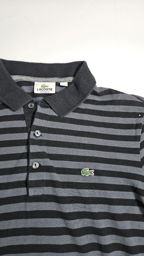 Lacoste Striped Polo Shirt (Category: Tshirts & Polo Shirts ) located in Alfonso. Submitted by jbcamet (Listing ID 1462415587, Image 2). Description: - Classic Lacoste polo shirt - Stylish black and grey stripes - Iconic crocodile logo on chest - Made from 100% premium cotton - Comfortable regular fit - Ideal for everyday casual wear.