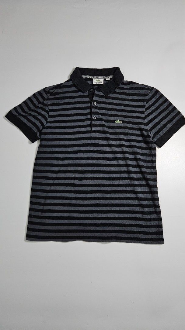 Lacoste Striped Polo Shirt (Category: Tshirts & Polo Shirts ) located in Alfonso. Submitted by jbcamet (Listing ID 1462415587, Image 1). Description: - Classic Lacoste polo shirt - Stylish black and grey stripes - Iconic crocodile logo on chest - Made from 100% premium cotton - Comfortable regular fit - Ideal for everyday casual wear.