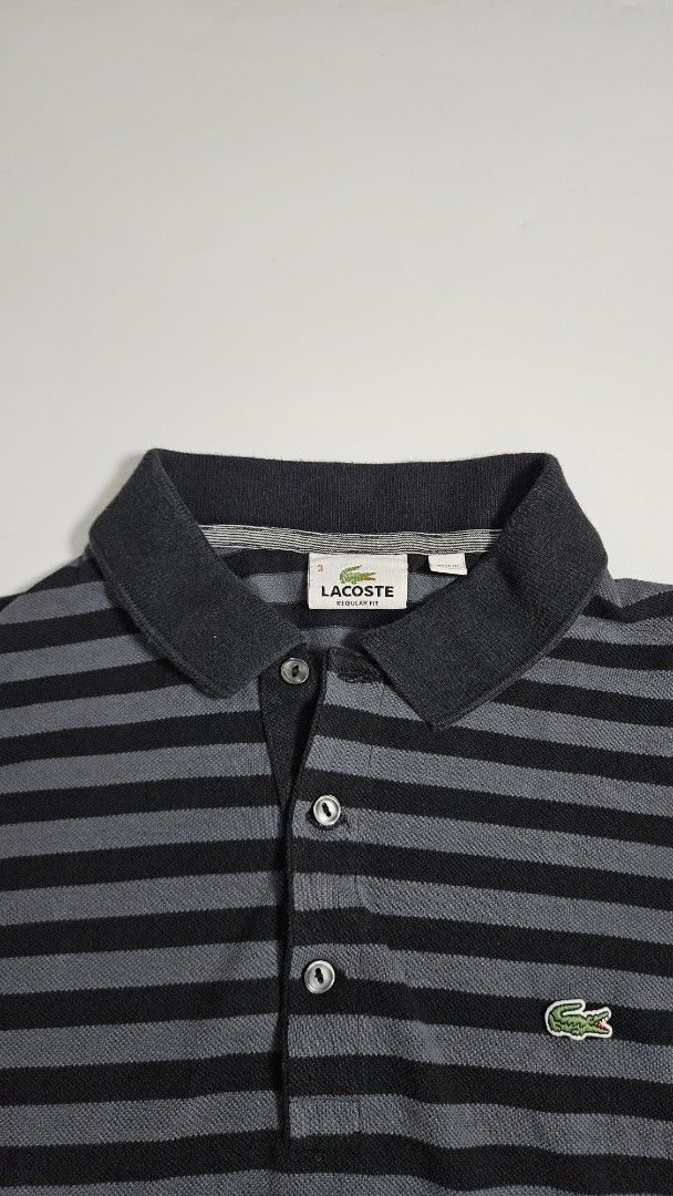 Lacoste Striped Polo Shirt (Category: Tshirts & Polo Shirts ) located in Alfonso. Submitted by jbcamet (Listing ID 1462415587, Image 3). Description: - Classic Lacoste polo shirt - Stylish black and grey stripes - Iconic crocodile logo on chest - Made from 100% premium cotton - Comfortable regular fit - Ideal for everyday casual wear.