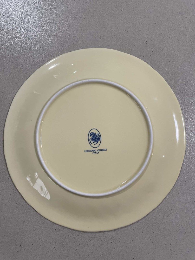 Leonardo Cenziale Italy Embossed Grape Leaf Plate (Category: Other Kitchenware & Tableware) located in Quezon City. Submitted by meggoquingco (Listing ID 1462342338, Image 2). Description: - Elegant cream-colored plate - Features embossed grape and leaf design around the rim - Made in Italy by Leonardo Cenziale - Approximately 9.5 inches in diameter - Ideal for serving dishes or as a decorative display piece.