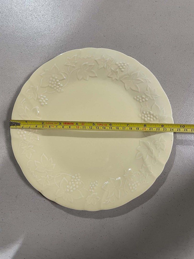 Leonardo Cenziale Italy Embossed Grape Leaf Plate (Category: Other Kitchenware & Tableware) located in Quezon City. Submitted by meggoquingco (Listing ID 1462342338, Image 3). Description: - Elegant cream-colored plate - Features embossed grape and leaf design around the rim - Made in Italy by Leonardo Cenziale - Approximately 9.5 inches in diameter - Ideal for serving dishes or as a decorative display piece.