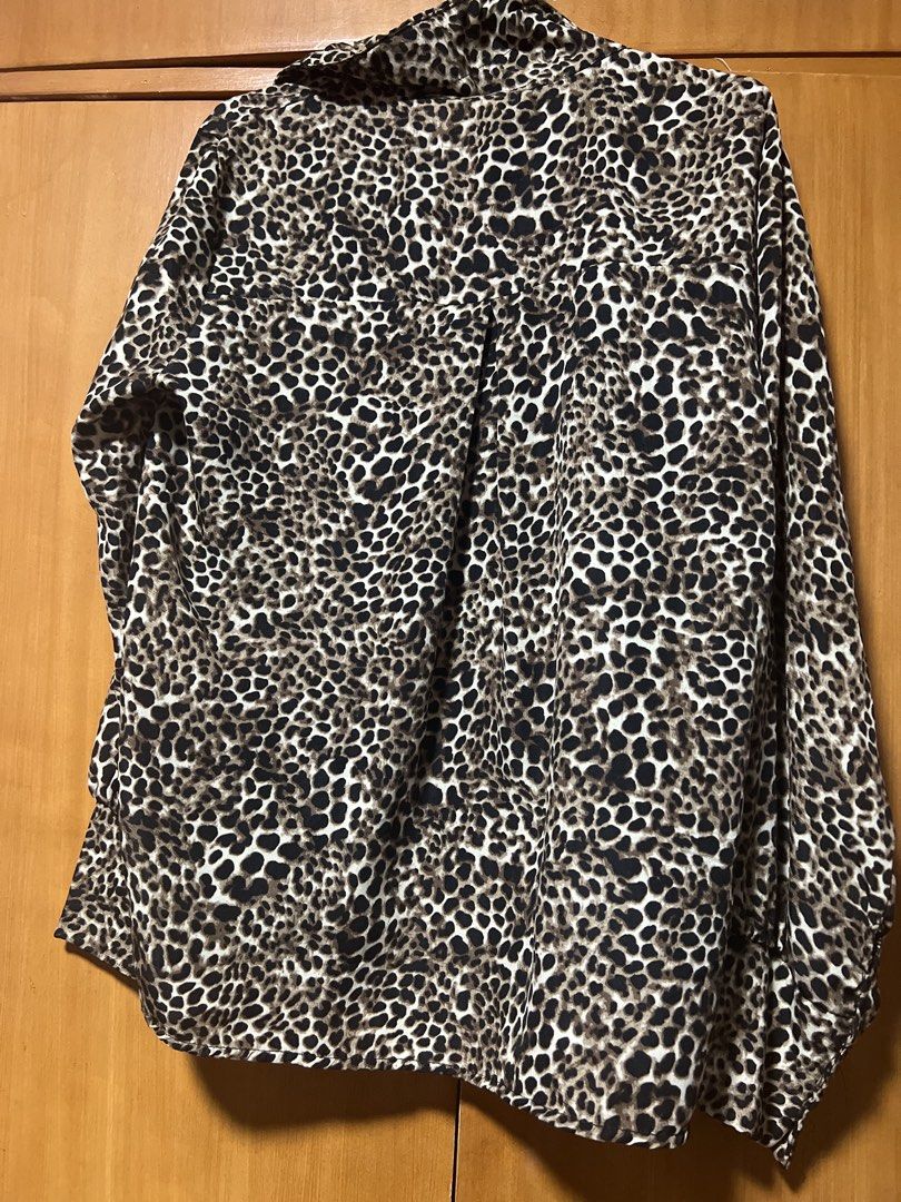 Leopard Print Button-Up Shirt with Fur Accents (Category: Shirts) located in Pasig City. Submitted by zebteashoppe01 (Listing ID 1462404805, Image 3). Description: - Trendy leopard print long-sleeve shirt - Features fuzzy fur details on pockets and collar - Classic button-up front - Perfect for making a bold fashion statement.