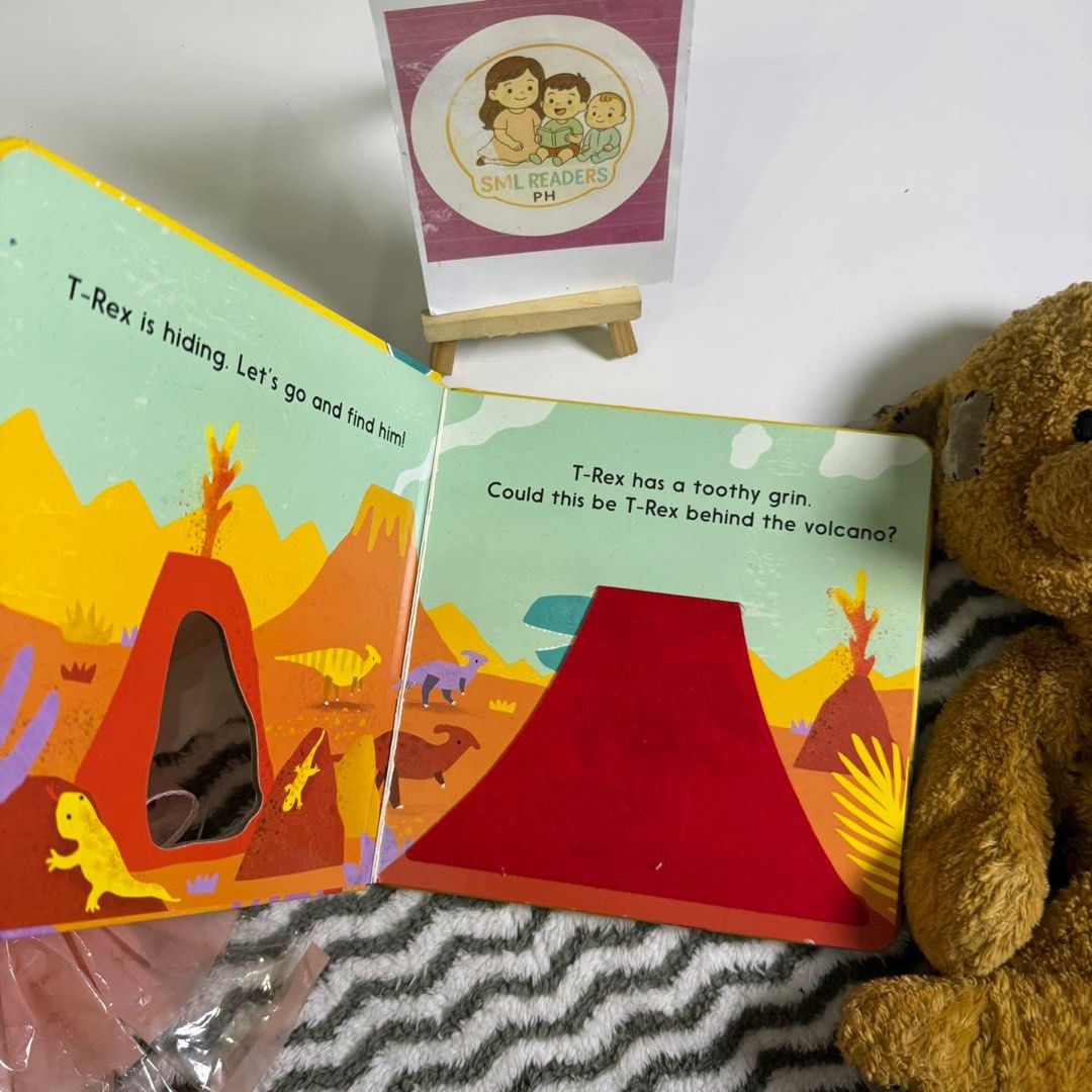 Let’s Find the Dinosaur (Category: Children's Books) located in Taguig. Submitted by smlreadersph (Listing ID 1462362355, Image 2). Description: 💗 𝐋𝐞𝐭’𝐬 𝐅𝐢𝐧𝐝 𝐭𝐡𝐞 𝐃𝐢𝐧𝐨𝐬𝐚𝐮𝐫 🦖🌿 Interactive Board Book • Little Tiger 📖 Condition: Preloved condition with cute felt flaps inside! 🥰 One page may need a little glue for stronger binding, but the rest of the pages are in very good to excellent condition. 👧👦 Age Recommended: 1–4 year
