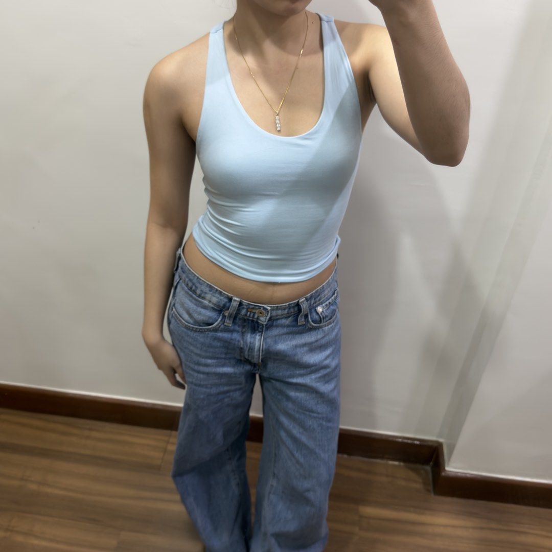 Light Blue Racerback Top (Category: Sleeveless) located in Quezon City. Submitted by miumuse_ (Listing ID 1462307506, Image 2). Description: - Light blue tank top - Flattering and stretchy fit - Perfect with high-waisted bottoms - Versatile for dressing up or down.