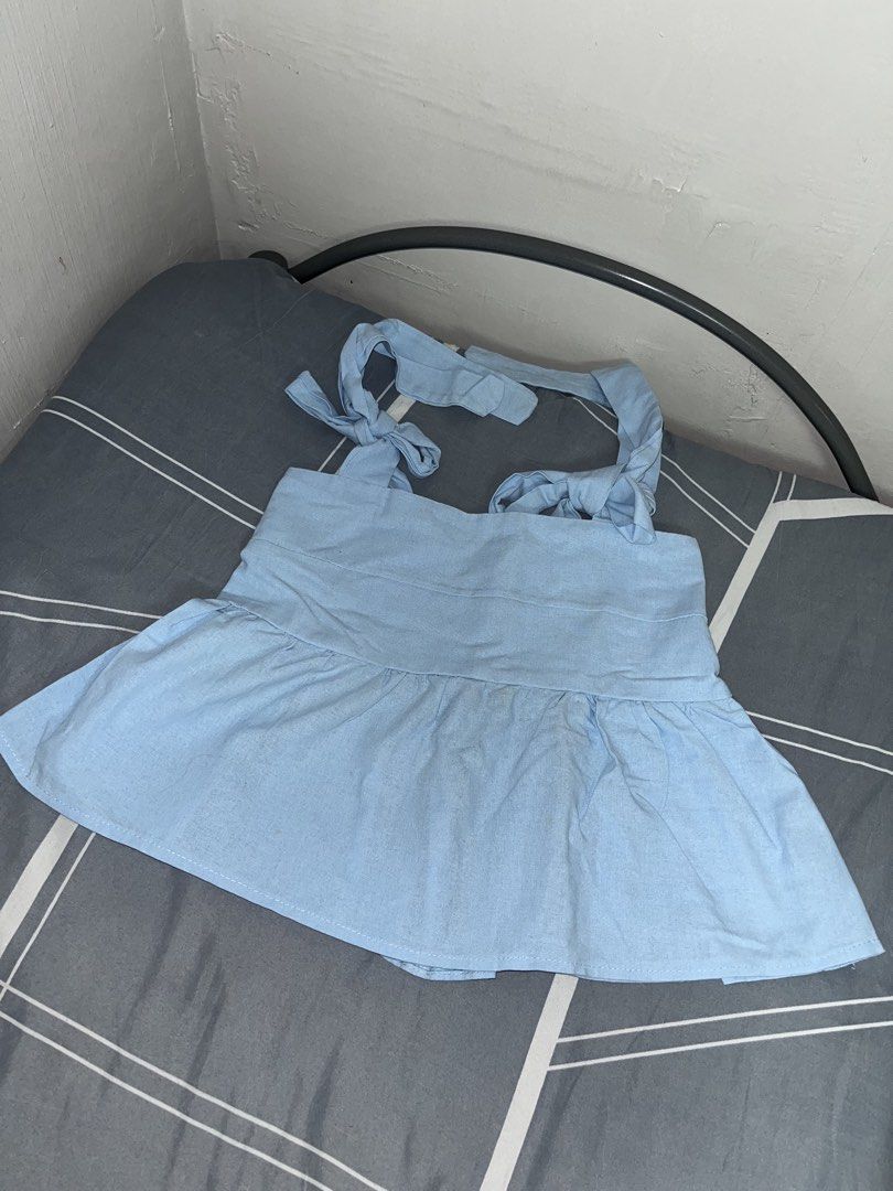 Light Blue Tie-Strap Peplum Top (Category: Sleeveless) located in Manila. Submitted by thelvieee (Listing ID 1462313526, Image 1). Description: - Adorable light blue peplum top - Features adjustable tie straps on the shoulders - Cinched waist with gathered detail for a flattering fit - Flared peplum hem for a feminine silhouette - Estimated size: Small to Medium - Ideal for a stylish and casual day out.